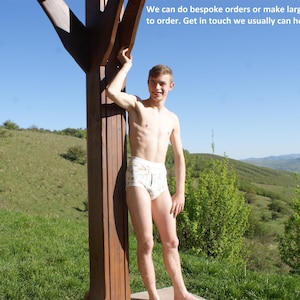 May include: White patterned briefs with an elastic waistband. The image includes the text: We can do bespoke orders or make larger or smaller sizes to order. Get in touch we usually can help.