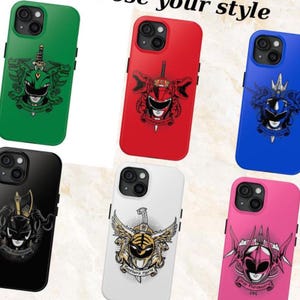 May include: A collection of colorful phone cases featuring Power Ranger designs. The cases are in various colors, including green, red, blue, black, white, and pink. Each case has a unique graphic of a Power Ranger character.