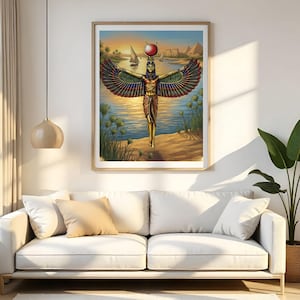 May include: A framed print of an Egyptian goddess with outstretched wings, standing near a river. The artwork features vibrant colors, including red, gold, and blue, with pyramids and a sunset in the background. The print is displayed above a white sofa.