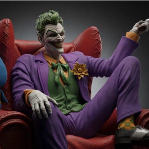 May include: A detailed figurine of a character with green hair and white skin, wearing a purple suit, green vest, orange shirt, and white gloves. The character sits in a red armchair, featuring a yellow flower lapel pin and black and white shoes.