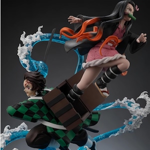 May include: A dynamic anime-style figurine featuring two characters in motion. One character wears a green and black checkered haori, while the other, with long black hair and a bamboo muzzle, leaps from a brown wooden box. Translucent blue water effects swirl around them.