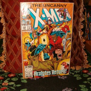 May include: A comic book cover for "The Uncanny X-Men" issue #298, featuring a dynamic illustration of several characters in action. The cover has the text "Acolytes Return!" and "30 Years X-Men 1963-1993".