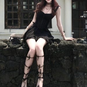 Lace Trim Mini Dress | Slim Fit Sleeveless Style | Y2K Gothic Grunge Streetwear

Lace trim slim mini dress with bow detail designed for women gothic styling and chic everyday outfits.