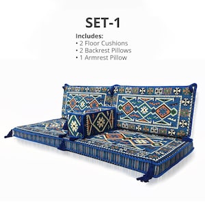 May include: A blue floor seating set with geometric patterns. The set includes two floor cushions, two backrest pillows, and one armrest pillow. The cushions and pillows have a blue border and tassels.