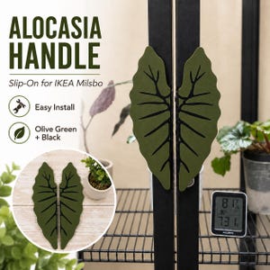 May include: Two olive green, leaf-shaped slip-on handles for an IKEA Milsbo cabinet. The handles feature a black vein pattern resembling an Alocasia leaf. Text on the image reads: ALOCASIA HANDLE, Slip-On for IKEA Milsbo, Easy Install, Olive Green + Black.