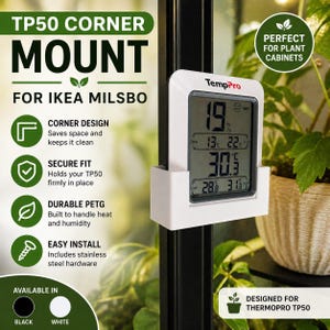 May include: White TP50 corner mount for IKEA Milsbo. The mount holds a TempPro digital thermometer, displaying temperature and humidity readings. The mount is designed for plant cabinets and is available in black or white.