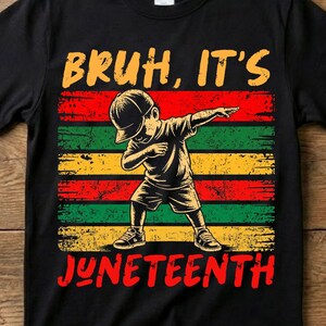 以下が含まれることがあります： 黒いTシャツ。子供がダブをしているグラフィックで、赤と黄色の「BRUH, IT'S JUNETEENTH」という文字が入っています。デザインは赤、緑、黄色のストライプが特徴です。シャツには「BUY 1 GET 1 FREE」という文字が入っています。
