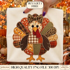 May include: A cream-colored t-shirt featuring a central turkey graphic made of various fabric patches in autumn colors like orange, brown, and green with floral, plaid, and leopard patterns. The turkey has a bow on its head and the text BUY 1 GET 1 FREE.
