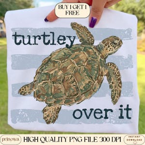 May include: White t-shirt featuring a detailed illustration of a sea turtle in shades of green and brown. The text "turtley over it" is printed in dark blue. The shirt also has the text "HIGH QUALITY PNG FILE 300 DPI".