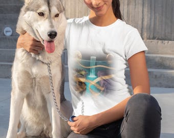 May include: A white t-shirt with a colourful graphic print of a waterfall scene in blue and gold tones. A woman is wearing the shirt and is sitting next to a grey and white Siberian Husky dog. The dog is on a leash.