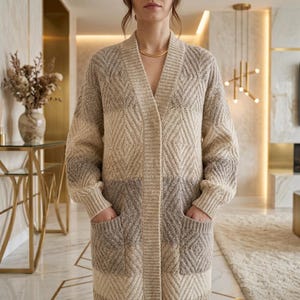 May include: A long-sleeved, open-front cardigan featuring a textured diamond pattern in shades of beige, cream, and grey. The garment has a ribbed V-neckline, ribbed cuffs, and two large patch pockets on the front, crafted from a knit fabric.