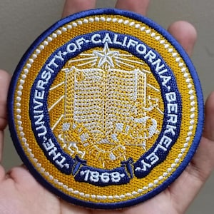 May include: Embroidered patch featuring the University of California, Berkeley seal. The circular patch has a blue border with white stitching, surrounding a gold center with the university name and a star. The year 1868 is displayed.