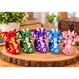 May include: Five crocheted dragon wristbands in red, green, purple, blue, and pink. Each dragon features small wings, a cream-colored belly, black plastic eyes, and a silver metal snap button closure on the band to secure it around the wrist.