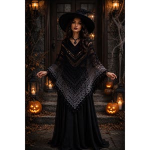 May include: A black and grey ombre crochet poncho featuring a V-neckline and a pointed hem with fringe detailing. The garment is worn over a long black skirt and is paired with a wide-brimmed black witch hat and a dark pendant necklace.