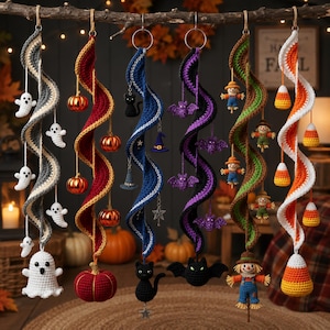 May include: Six hanging spiral crochet decorations featuring Halloween themes: a ghost, a pumpkin, a black cat, a bat, a scarecrow, and candy corn. Each spiral is suspended from a metal ring and adorned with matching crocheted charms.