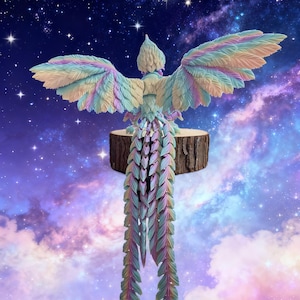 May include: A colorful, carved bird sculpture with outstretched wings, perched on a wooden base. The bird features pastel shades of blue, green, pink, and yellow. The background is a starry night sky with clouds.