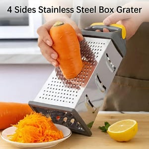 May include: A stainless steel box grater with a yellow and gray handle is used to grate a carrot. The grater has four sides and is sitting on a wooden surface. The text "4 Sides Stainless Steel Box Grater" is visible.