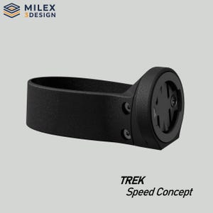 May include: Black bicycle computer mount with the text "TREK Speed Concept". The mount has a circular component with a patterned design and two screws. The brand logo "MILEX 3 DESIGN" is in the top left corner.