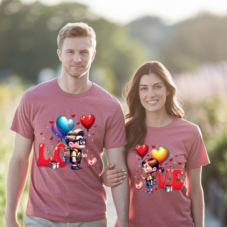 May include: Matching maroon t-shirts with a cartoon design featuring the word "LOVE" in red letters, balloons, and cartoon characters. The shirts are short-sleeved and worn by a man and a woman.