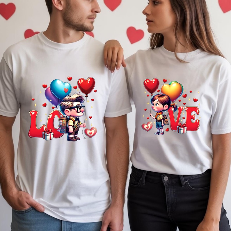 May include: White t-shirts with a "LOVE" graphic. The shirts feature cartoon illustrations of a boy and girl holding heart-shaped balloons. Red and blue heart decorations are scattered around the design, with a gift box next to the letter "L" and "V".