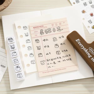 May include: A cream-colored reading notes paper sheet with black cat illustrations and Chinese text, a white vertical stamp block with six cat icons, and a brown rectangular stamp handle with the text Everything is MMar.
