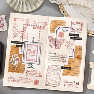 May include: Open notebook with scrapbook elements. Features include butterfly and floral stickers, stamps, and torn paper accents. Text includes "Life is pain, Highne purpose", "Factor", and "SPECIMEN". The color palette is primarily pink and brown.