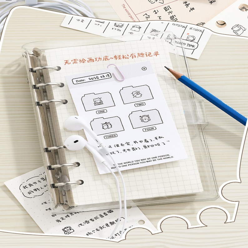 May include: A clear plastic ring binder with metal rings containing grid paper, a white card with cartoon folder icons labeled one through four, a blue pencil, and white wired earbuds. The card features the text Date: 2016.03.19.