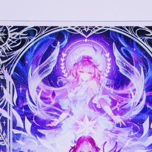 May include: A vibrant illustration featuring a female anime character with pink hair and a white dress. The artwork is set against a backdrop of blues and purples, with intricate details and a celestial theme. The image has a fantasy art style.