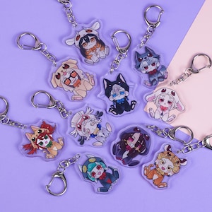 K&ouml;nnte beinhalten: Eine Sammlung von Acryl-Schl&uuml;sselanh&auml;ngern mit Anime-Charakteren in verschiedenen Tierkost&uuml;men. Jeder Schl&uuml;sselanh&auml;nger hat einen silbernen Verschluss. Die Charaktere sind in Braun-, Schwarz-, Wei&szlig;-, Orange- und Blaut&ouml;nen auf einem lila und rosa Hintergrund dargestellt.