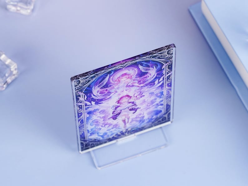 May include: A clear acrylic display featuring a vibrant illustration with purple and white hues. The artwork depicts a figure with flowing hair and ornate details, set against a celestial background. The display stands upright on a clear base.