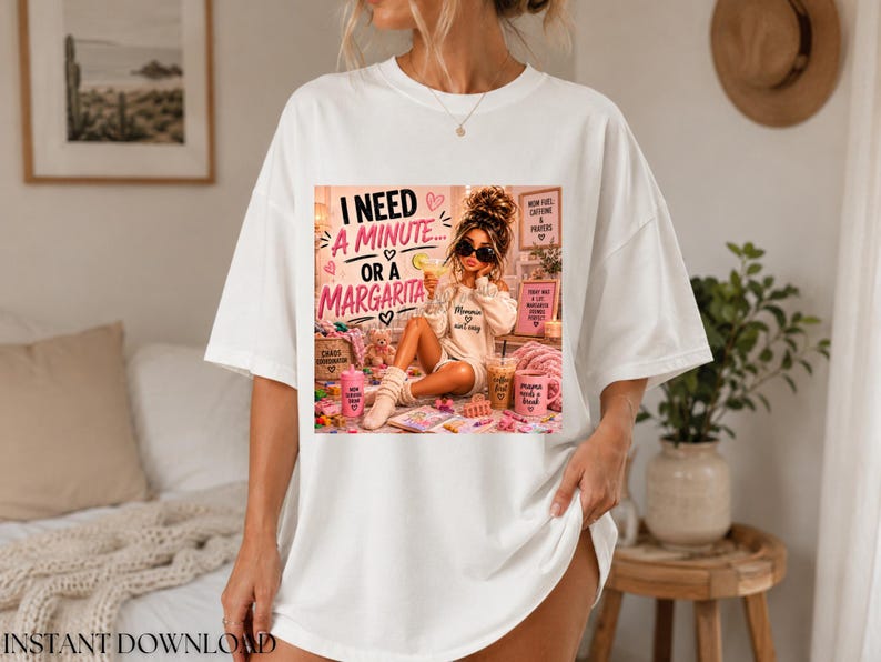 May include: A white short-sleeved t-shirt featuring a graphic print of a person with sunglasses sitting amidst various items, including a drink and a pink mug. The text reads: I NEED A MINUTE... OR A MARGARITA, MOM FUEL, CAFFEINE & PRAYERS, and more.