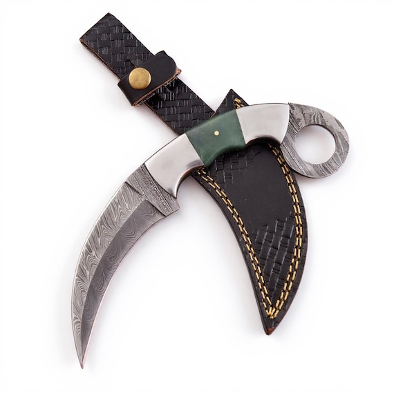 Hand-forged Damascus steel karambit with striking green camel bone handle — a functional blade that doubles as a piece of metallurgical art.