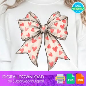 Puede incluir: Una sudadera blanca con una gran ilustración de lazo. El lazo es de color crema con un patrón de corazones rojos. Las palabras "DIGITAL DOWNLOAD" y "by SugarBloomDigital" están en la parte inferior.