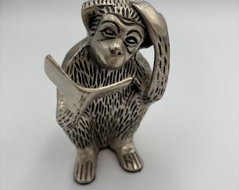 Vintage silver toned cast metal reading monkey