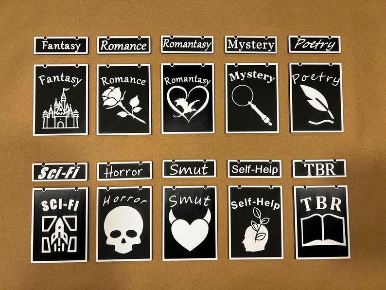 May include: Black and white genre-themed decorative signs. Each sign features a title like "Fantasy," "Romance," or "Mystery," along with a corresponding graphic. The signs are designed for book lovers and readers.