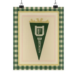 May include: A framed print featuring a green pennant with the text "DARTMOUTH" and "BIG GREEN". The pennant is set against a cream background with a pink and yellow border, and a green and white checkered frame.