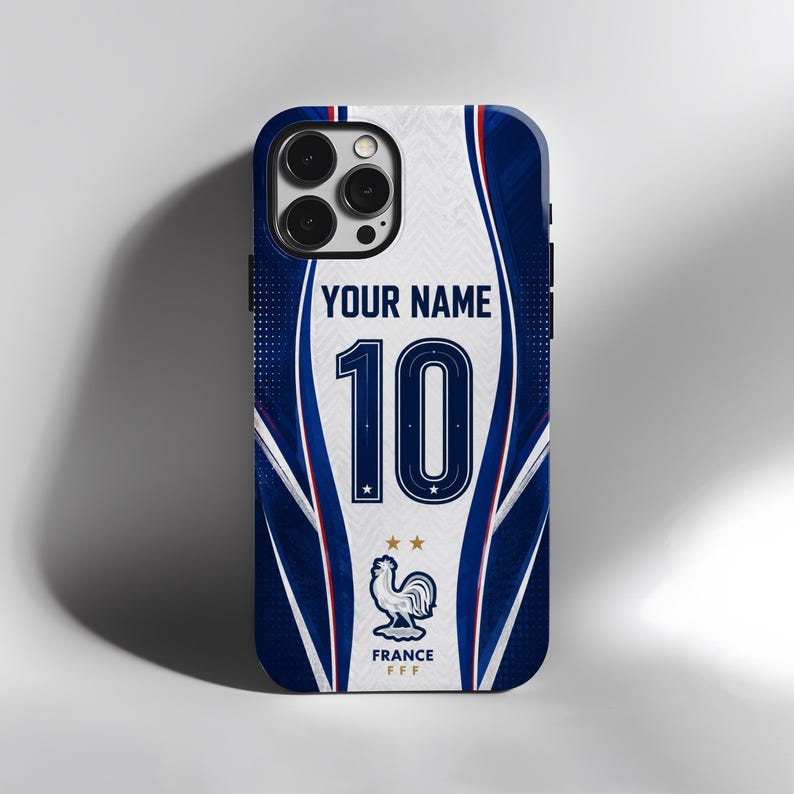 May include: A phone case featuring a blue and white design with the text YOUR NAME above the number 10. Below the number is a graphic of a rooster with two gold stars and the text FRANCE FFF. The case has a cutout for a triple camera system.