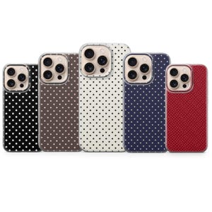 May include: A collection of five phone cases with a polka dot pattern. The cases are in various colors, including black, brown, cream, navy blue, and red. Each case has a clear camera lens protector.