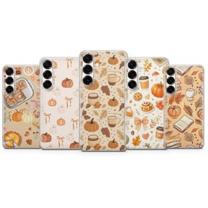 May include: Five clear smartphone cases arranged in a row, each featuring a distinct autumn-themed pattern. Designs include illustrations of pumpkins, cinnamon rolls, coffee cups, ghosts, bows, falling leaves, books, and pie slices in warm orange and brown tones.