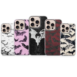 May include: A collection of five phone cases with bat designs. The cases feature various colors and patterns, including black and white, pink, and red. The bat illustrations vary in style, from silhouettes to detailed drawings.