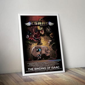 May include: A framed poster for "The Binding of Isaac: Rebirth" video game. The artwork features a central character with large eyes, surrounded by grotesque monsters. The title and release date, September 28, 2011, are displayed prominently.