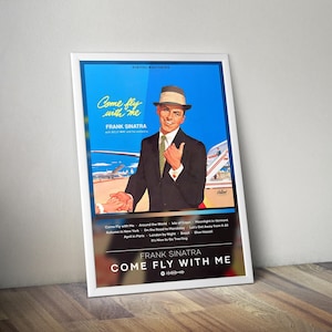May include: A framed poster featuring Frank Sinatra, titled "Come Fly With Me." The poster has a blue background with an image of Sinatra in a suit and fedora. The poster includes song titles and the Capitol Records logo.