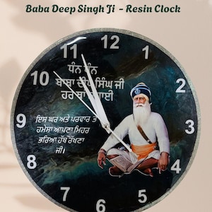 May include: A round resin clock featuring an image of Baba Deep Singh Ji. The clock face is black with white numerals and hands. The text "Baba Deep Singh Ji - Resin Clock" is at the top. The clock has a silver glitter border.