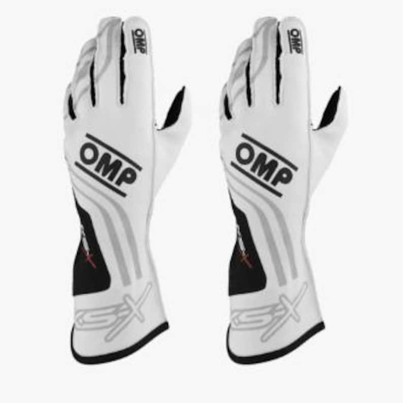 May include: A white ceramic mug with a black handle and the text "But First, Coffee" in a black, handwritten-style font. The mug is on a white surface.