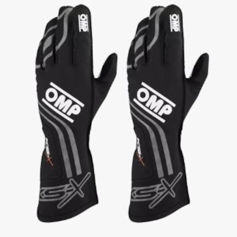 May include: Pair of black OMP racing gloves. The gloves feature white "OMP" logos, gray accents, and "GS-X" branding. The gloves are designed for motorsports and offer a professional look.
