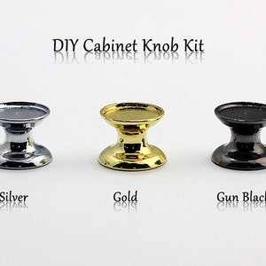 May include: DIY Cabinet Knob Kit with three knobs in silver, gold, and gun black finishes.  The knobs are round and have a raised center.