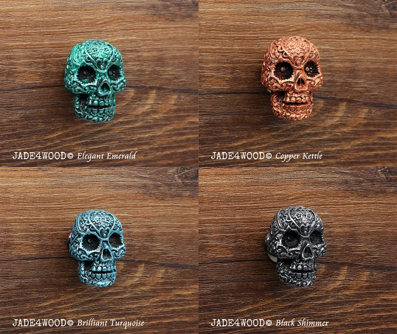 May include: Four decorative skull drawer pulls in different colors: elegant emerald, copper kettle, brilliant turquoise, and black shimmer. Each skull has intricate details and a unique finish.