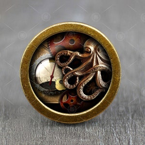 May include: A round, brass-colored pendant with a steampunk design featuring an octopus with gears and a clock face.