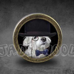 May include: A round, gold-toned image of a dog wearing a black top hat, monocle, and a blue bow tie with white polka dots. The dog is white with dark spots. The background is a textured gray.