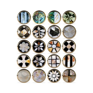 May include: Sixteen round cufflinks with diverse inlaid designs. The designs feature stripes, floral patterns, and geometric shapes, all set within gold-toned metal frames. The cufflinks display a variety of colours and textures.